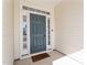 Beautiful blue front door framed by sidelights and transom window, offering a stylish welcome to the home at 517 Edenfield Dr, Fuquay Varina, NC 27526