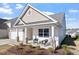 Charming home showcasing a cozy front porch with seating, stone accents, and landscaped garden beds at 517 Edenfield Dr, Fuquay Varina, NC 27526