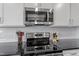 Kitchen featuring stainless steel appliances, granite countertops, and white cabinets at 517 Edenfield Dr, Fuquay Varina, NC 27526
