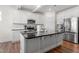 Kitchen island featuring granite countertops, white cabinets, stainless steel appliances, and an open layout at 517 Edenfield Dr, Fuquay Varina, NC 27526