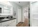 Clean bathroom showcasing a granite vanity, white cabinetry, and a modern shower with glass doors at 520 Tall Oaks Dr, Durham, NC 27713