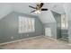 Well-lit bedroom with carpet, fan, and window with shutters at 520 Tall Oaks Dr, Durham, NC 27713