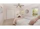 Bright bedroom with two beds, a built-in closet, carpeted floor and a ceiling fan with light at 520 Tall Oaks Dr, Durham, NC 27713