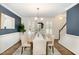 Dining room featuring stylish wall color, plantation shutters, a decorative chandelier, and seating for six at 520 Tall Oaks Dr, Durham, NC 27713
