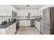 Modern kitchen features white cabinetry, stainless steel appliances, subway tile backsplash, and elegant lighting fixtures at 520 Tall Oaks Dr, Durham, NC 27713