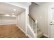 Hallway with a staircase and access to a finished basement featuring durable wood-look flooring at 520 Tall Oaks Dr, Durham, NC 27713
