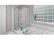 Bathroom featuring soaking tub and shower with glass block window offering natural light at 5405 Whisperwood Dr, Durham, NC 27713