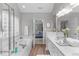 Large bathroom with double vanities, soaking tub, separate shower, and wood look flooring at 5405 Whisperwood Dr, Durham, NC 27713