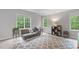Bedroom featuring three windows, a futon, and a patterned rug at 5405 Whisperwood Dr, Durham, NC 27713