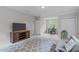 Bedroom featuring a TV on a stand, a desk, and a gray sofa at 5405 Whisperwood Dr, Durham, NC 27713