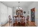 Formal dining room with wood floors, a chandelier, and elegant furnishings, adjacent to the kitchen at 5405 Whisperwood Dr, Durham, NC 27713