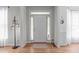 Entryway with hardwood floors, white trim, a stylish floor lamp, and natural light at 5405 Whisperwood Dr, Durham, NC 27713