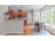 Eat-in kitchen area with hardwood floors, stainless appliances, and a view of the yard at 5405 Whisperwood Dr, Durham, NC 27713