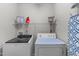 Laundry room featuring a washer, dryer, shelf and laundry-themed decoration at 5405 Whisperwood Dr, Durham, NC 27713