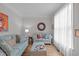 Cozy living room with stylish light blue couches, hardwood flooring, and plenty of natural light at 5405 Whisperwood Dr, Durham, NC 27713