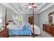 Spacious main bedroom featuring hardwood furniture, trey ceilings and soft natural light at 5405 Whisperwood Dr, Durham, NC 27713