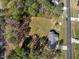 Aerial view of a home with a spacious backyard, patio area, and surrounded by mature trees at 55 Northdale Ct, Louisburg, NC 27549