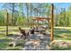 Beautiful backyard featuring a stone patio, pergola, fire pit, and outdoor seating area at 55 Northdale Ct, Louisburg, NC 27549