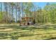 Lush backyard featuring a pergola with comfortable seating, a fire pit, and ample green space at 55 Northdale Ct, Louisburg, NC 27549