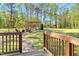 Spacious backyard featuring a stone walkway leading to a pergola with an outdoor seating area at 55 Northdale Ct, Louisburg, NC 27549