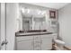 Bathroom with double vanity, white cabinets, and updated fixtures at 55 Northdale Ct, Louisburg, NC 27549