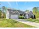 Charming single-story home with gray siding, attached garage, and well-manicured lawn at 55 Northdale Ct, Louisburg, NC 27549