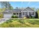 Charming single-story home features a well-maintained lawn, attached garage, and inviting front porch at 55 Northdale Ct, Louisburg, NC 27549