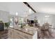 Open concept kitchen with an island featuring granite countertops, stainless steel appliances, and pendant lighting at 55 Northdale Ct, Louisburg, NC 27549