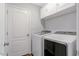 Laundry room with washer, dryer, and storage cabinets at 55 Northdale Ct, Louisburg, NC 27549