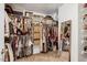 Organized walk-in closet with ample shelving, hanging space, and a full length mirror at 55 Northdale Ct, Louisburg, NC 27549