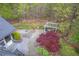 Aerial view of a home's landscaped backyard, including a stone patio and white pergola at 5900 Orchid Valley Rd, Raleigh, NC 27613
