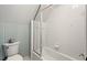 Bathroom featuring striped walls, a toilet, and bathtub-shower combo at 5900 Orchid Valley Rd, Raleigh, NC 27613
