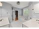 Elegant bathroom featuring double sinks, a large tub, and a glass-enclosed shower at 5900 Orchid Valley Rd, Raleigh, NC 27613