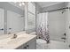 Bathroom features a vanity, toilet, and shower with a decorative shower curtain at 5900 Orchid Valley Rd, Raleigh, NC 27613