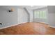 A second bedroom featuring wood-look floors, a window with shutters, and neutral paint at 5900 Orchid Valley Rd, Raleigh, NC 27613