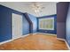 Bright bedroom features hardwood floors, a ceiling fan and a double door closet at 5900 Orchid Valley Rd, Raleigh, NC 27613