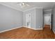 Bright bedroom featuring hardwood floors, a ceiling fan, and an attached bathroom at 5900 Orchid Valley Rd, Raleigh, NC 27613