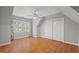 A well lit bedroom with hardwood floors, large window and closet space at 5900 Orchid Valley Rd, Raleigh, NC 27613