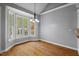 Bright dining area features a bay window, hardwood floors, and contemporary lighting at 5900 Orchid Valley Rd, Raleigh, NC 27613