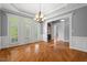 Elegant dining room with hardwood floors, a chandelier, and plantation shutters at 5900 Orchid Valley Rd, Raleigh, NC 27613