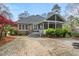Rear exterior showing the brick home and the stone patio leading up to the screened porch at 5900 Orchid Valley Rd, Raleigh, NC 27613