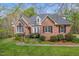 Beautiful brick home with a manicured lawn and shrubbery adding to its curb appeal at 5900 Orchid Valley Rd, Raleigh, NC 27613