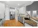 Kitchen with a stainless steel refrigerator and views to the dining and stairs at 5900 Orchid Valley Rd, Raleigh, NC 27613