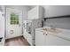 Laundry room with modern appliances and ample cabinet storage at 5900 Orchid Valley Rd, Raleigh, NC 27613