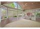 Enjoy outdoor living on this spacious screened porch with wooded views at 5900 Orchid Valley Rd, Raleigh, NC 27613