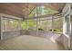 Inviting sunroom with vaulted ceiling and walls of windows offering picturesque outdoor views at 5900 Orchid Valley Rd, Raleigh, NC 27613