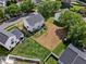 Aerial view showcasing the house with a spacious backyard, trees, and surrounding residential area at 6102 Coronado Ln, Durham, NC 27713