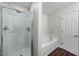 Bathroom featuring a glass shower, a large tub, dark wood floors, and neutral paint at 6102 Coronado Ln, Durham, NC 27713