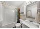 This bathroom is equipped with a shower-tub combo, cabinet and sink, providing a functional space at 6102 Coronado Ln, Durham, NC 27713