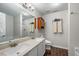 Bathroom features a double vanity, a shower-tub combo, with wood style floors and neutral paint at 6102 Coronado Ln, Durham, NC 27713